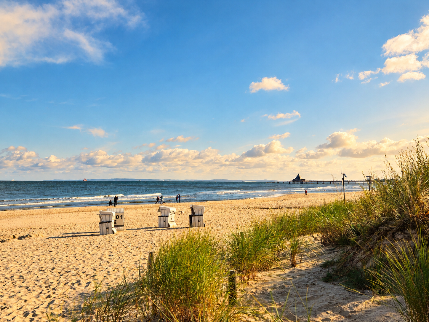 Ostseestrand in Heringsdorf mit blauem Himmel, Strandkörben und Dünen